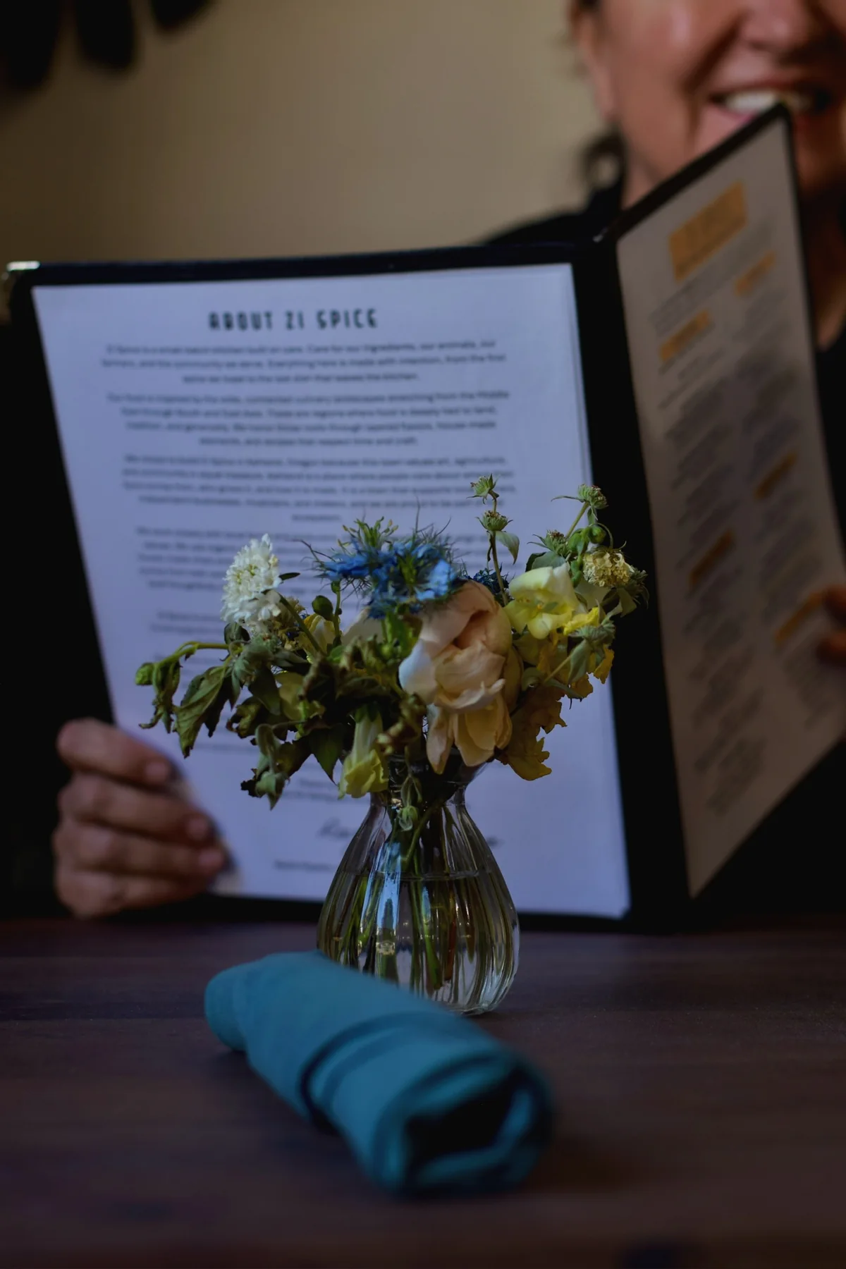 Restaurant menu and flowers on a table