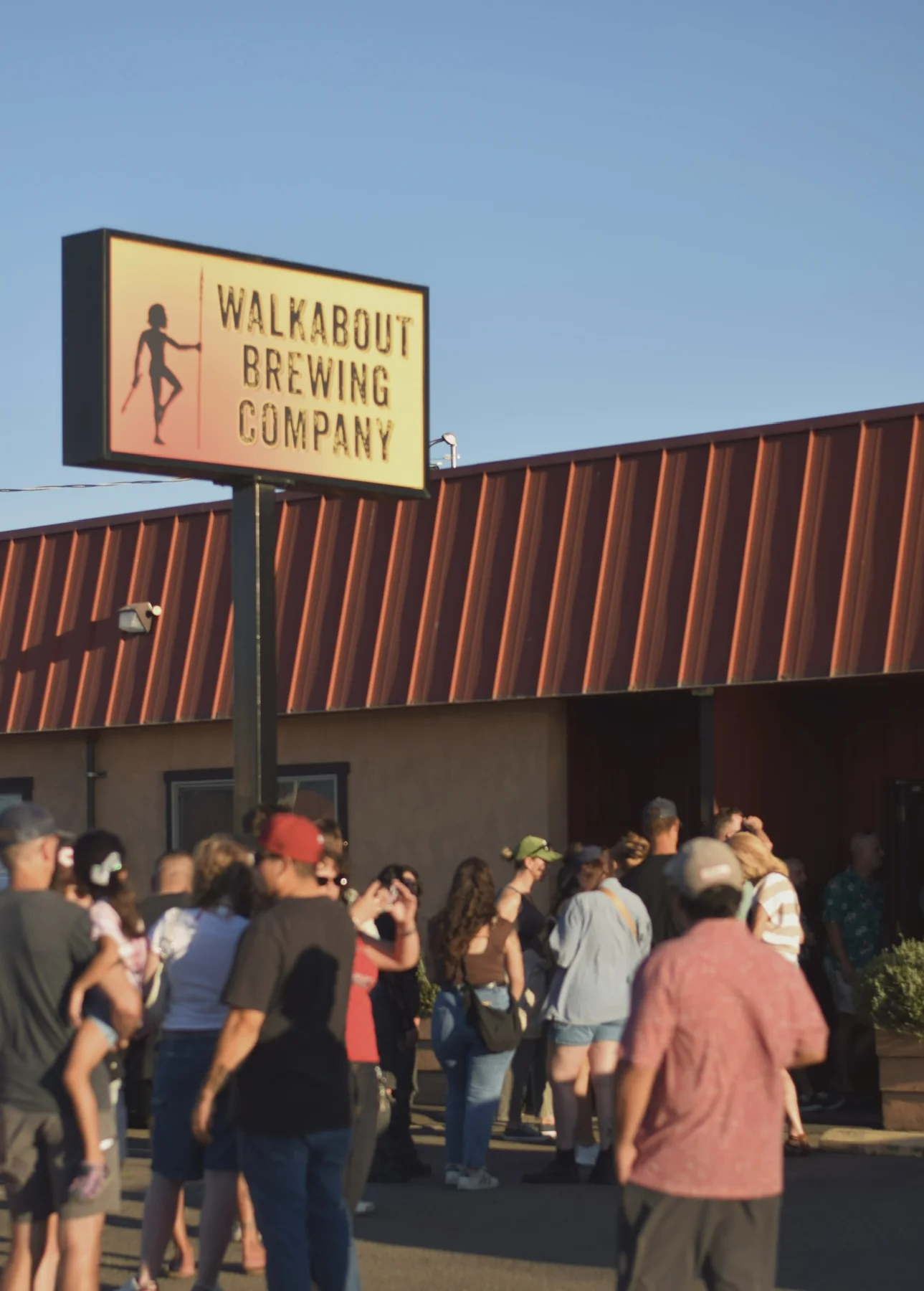 People gathering outside a local brewery